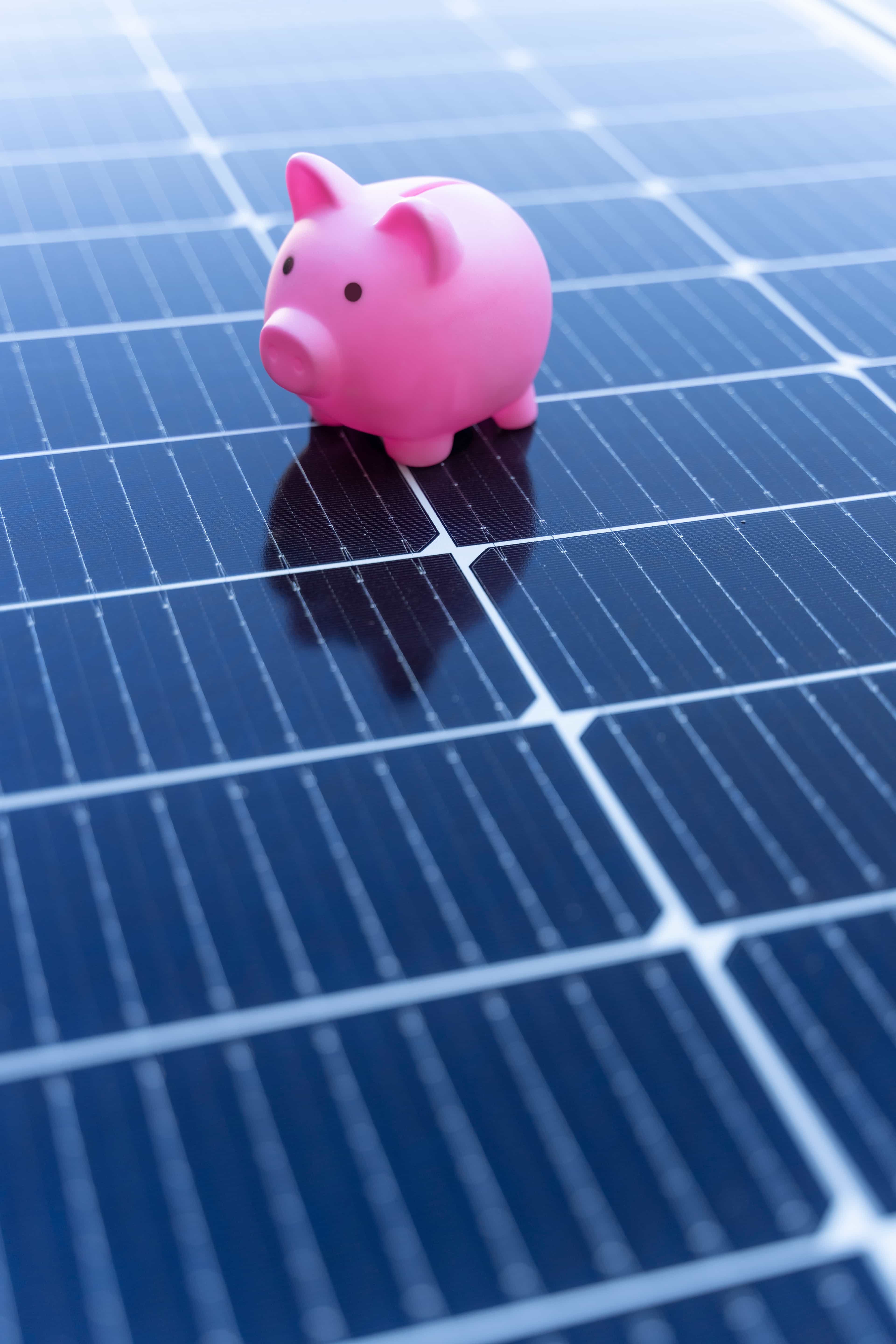 A piggy bank on a set of solar panels