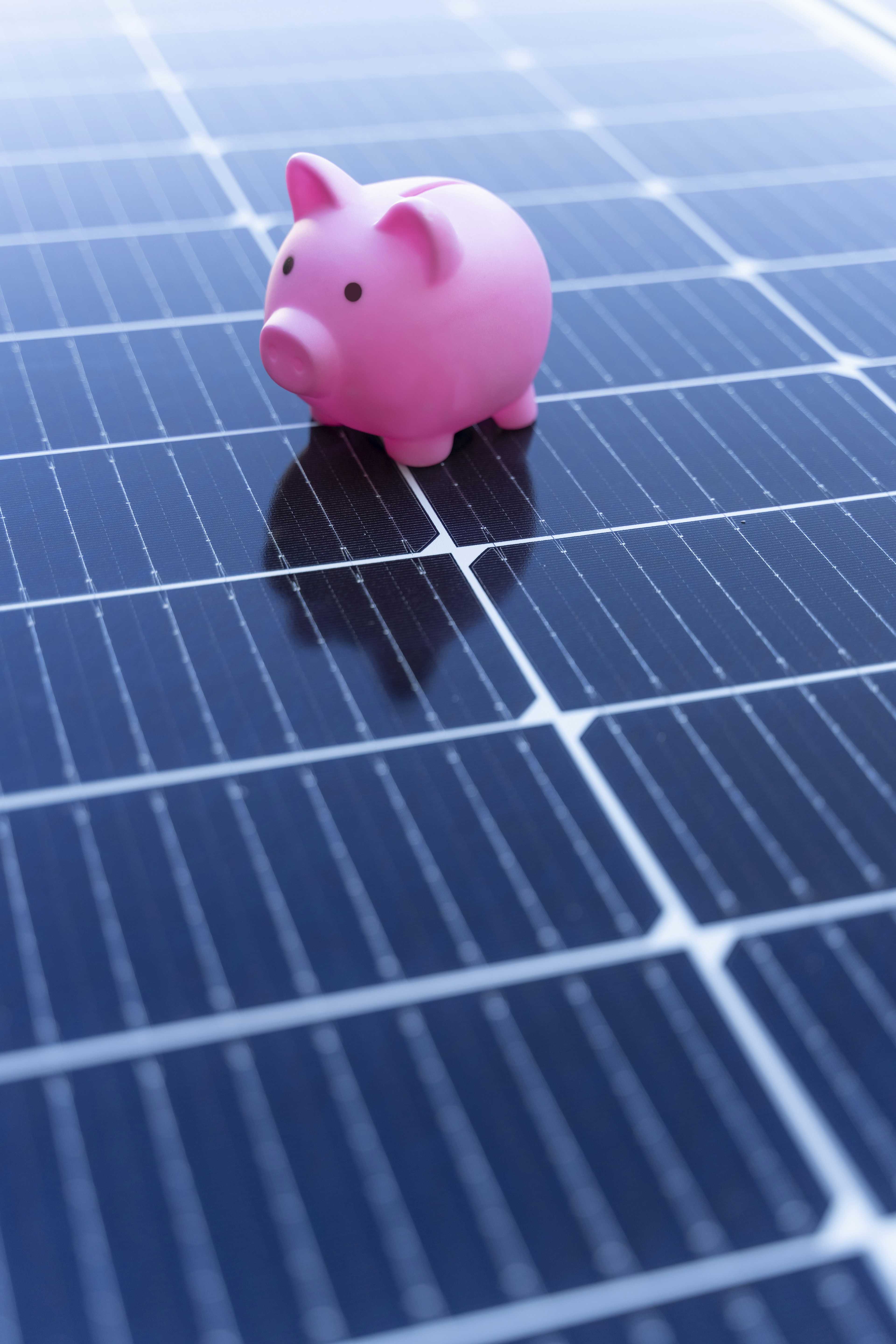 A piggy bank on a set of solar panels